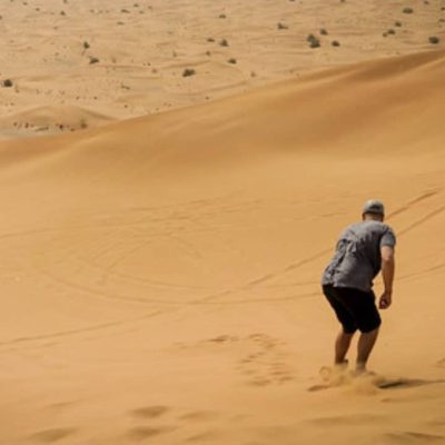 Sand boarding in desert Dubai UAE