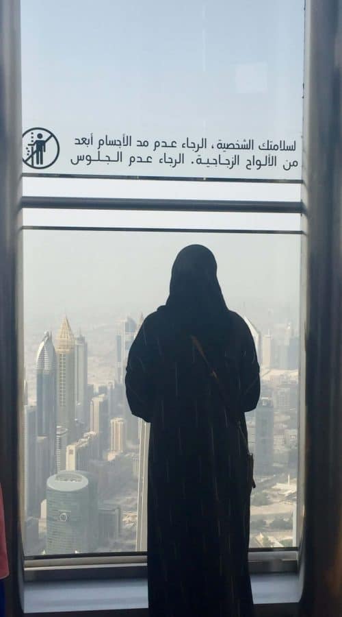 Burj Khalifa woman looking out from top of Burj Khalifa