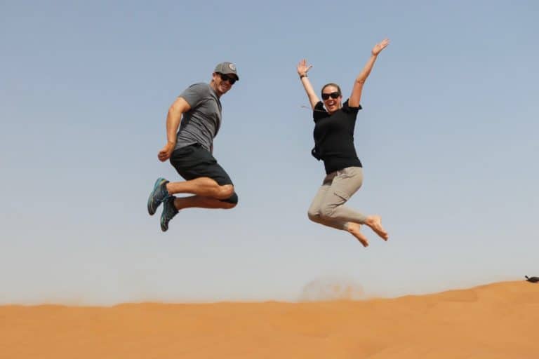 Jumping in the air in Dubai desert.