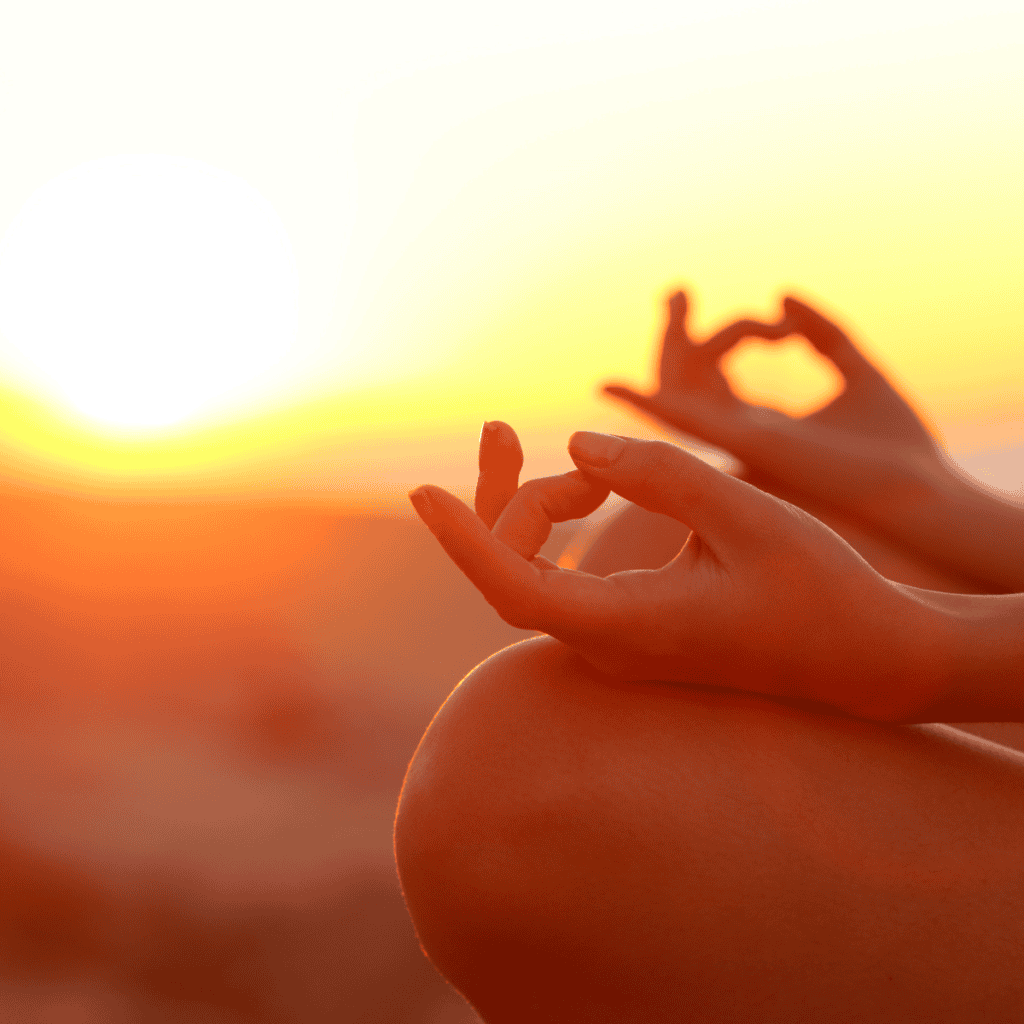 Practicing yoga at sunset.