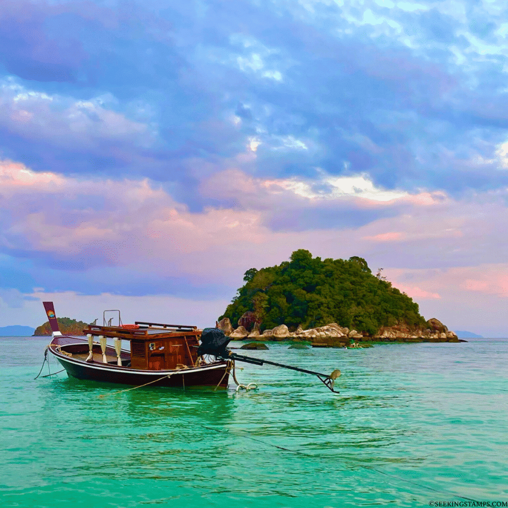 Long tail boat and Ko Unsen island from Sunrise Beach in Koh Lipe.