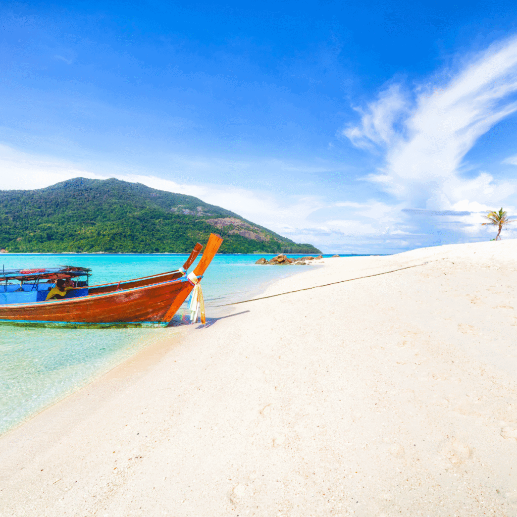 long-tail boat on white sand Bulow Beach Koh Lipe.