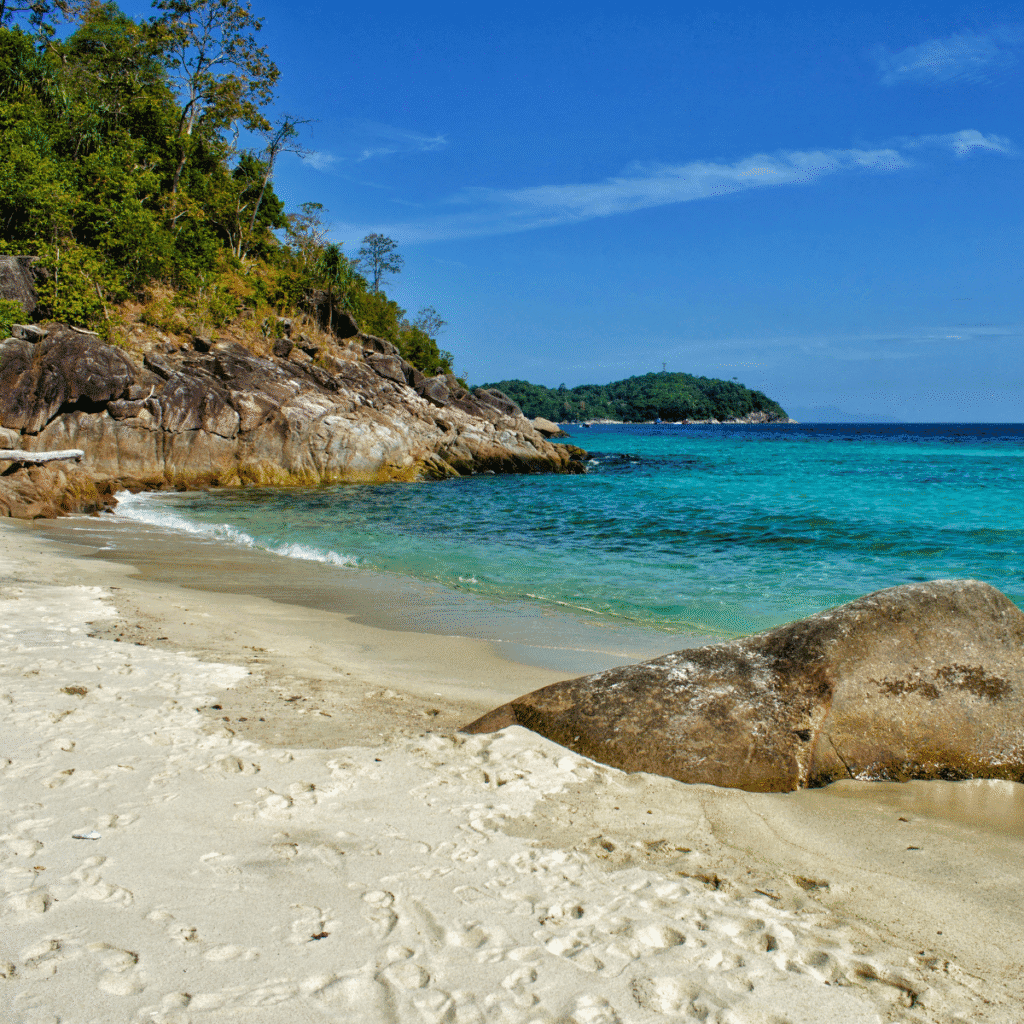 Sandy beach and rocks at Pantai Galah Beach in Koh Lipe.